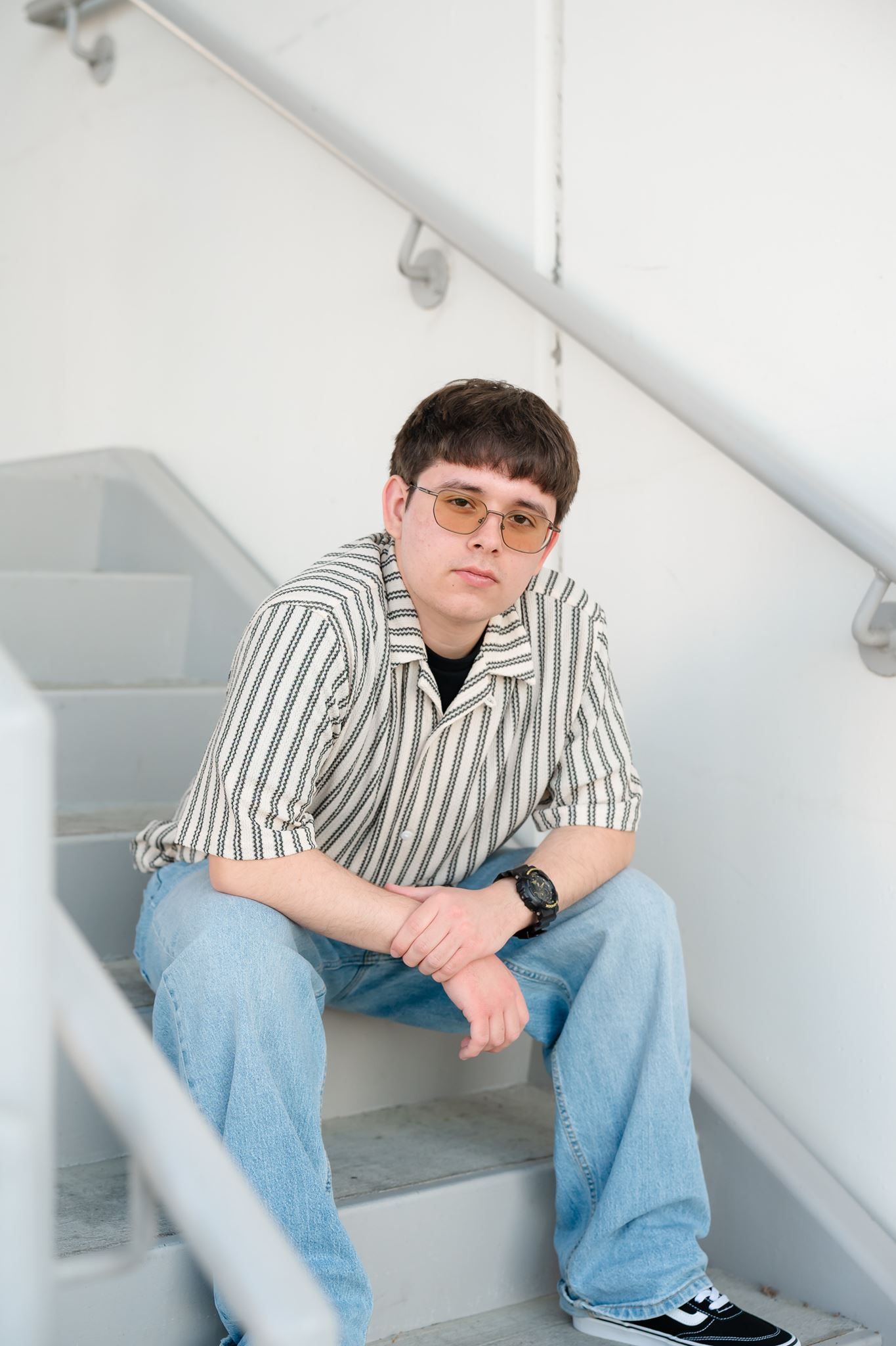 Conroe High School senior guy posing at a parking garage in The Woodlands Texas