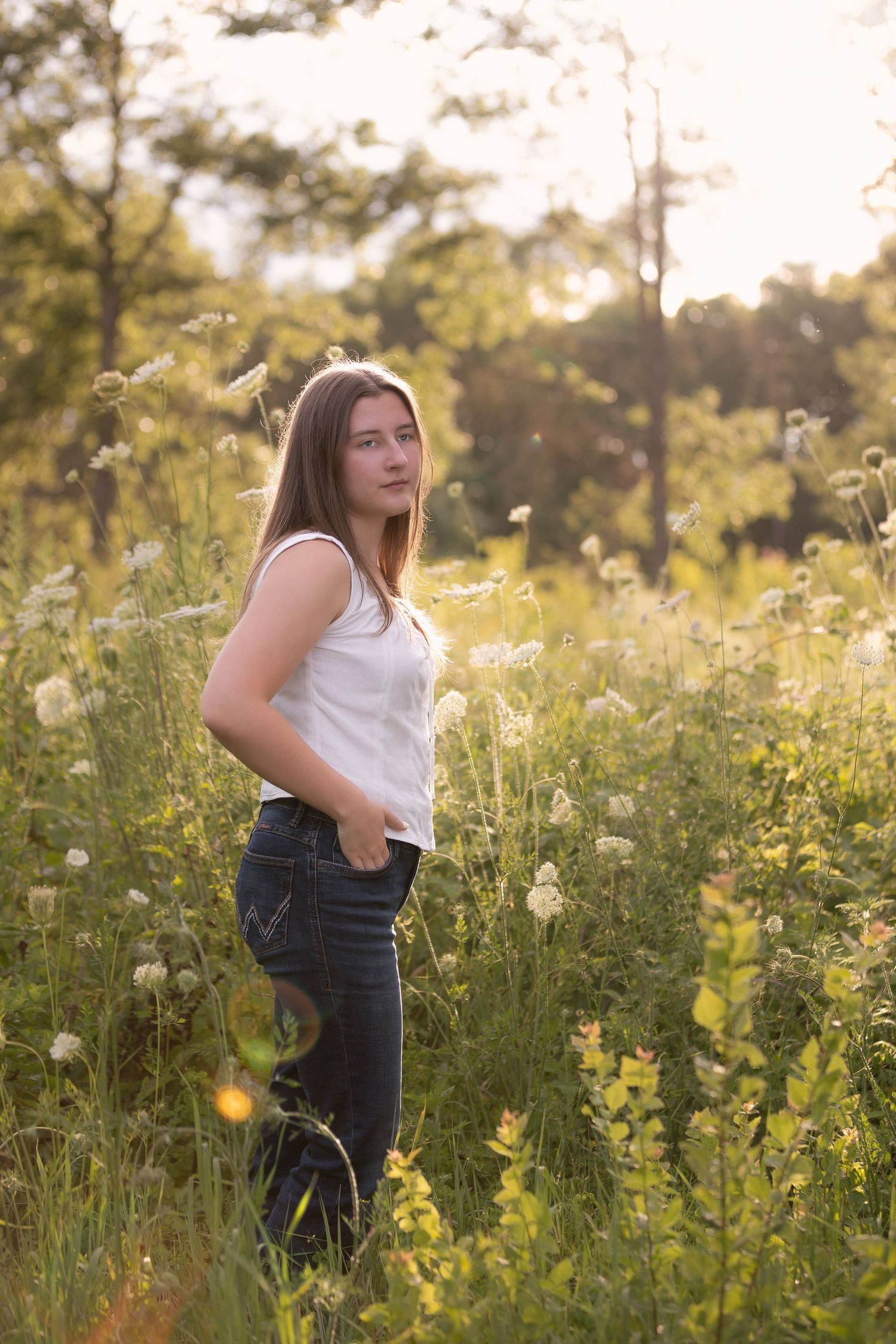High school senior girl pictures in flower field; summer senior photos in Brighton, Michigan by South Lyon portrait photographer