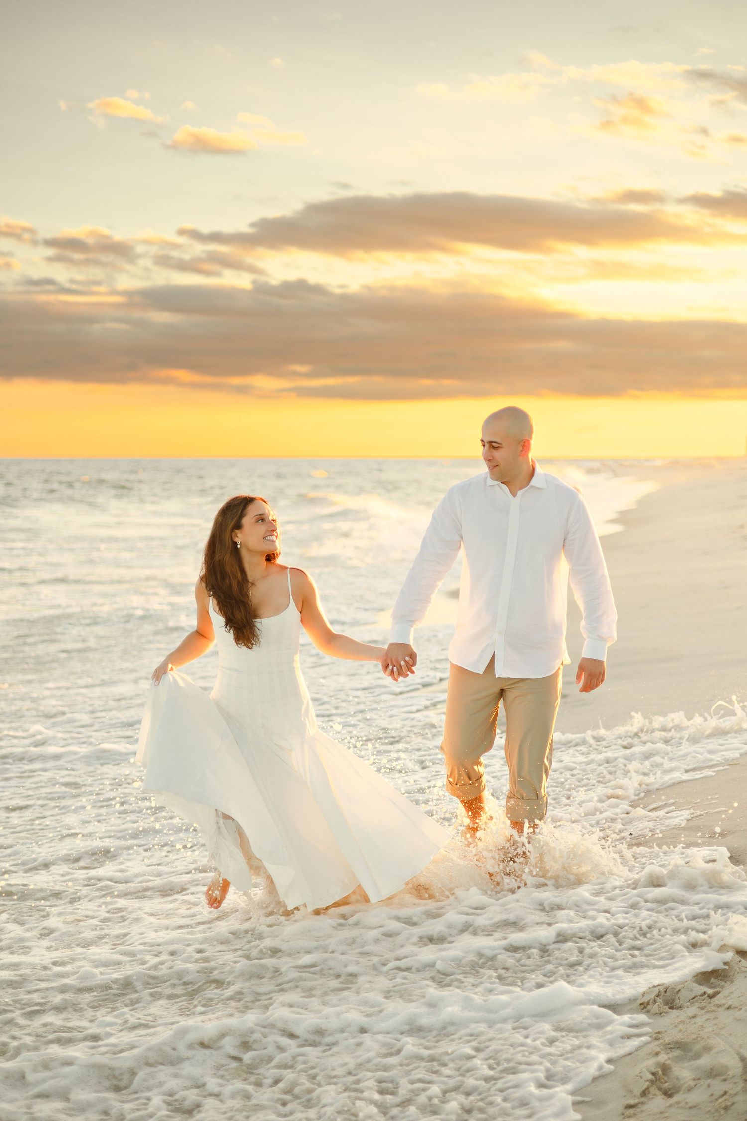 A romantic proposal scene set between rows of grapevines in a scenic vineyard with white flowers and a blanket.