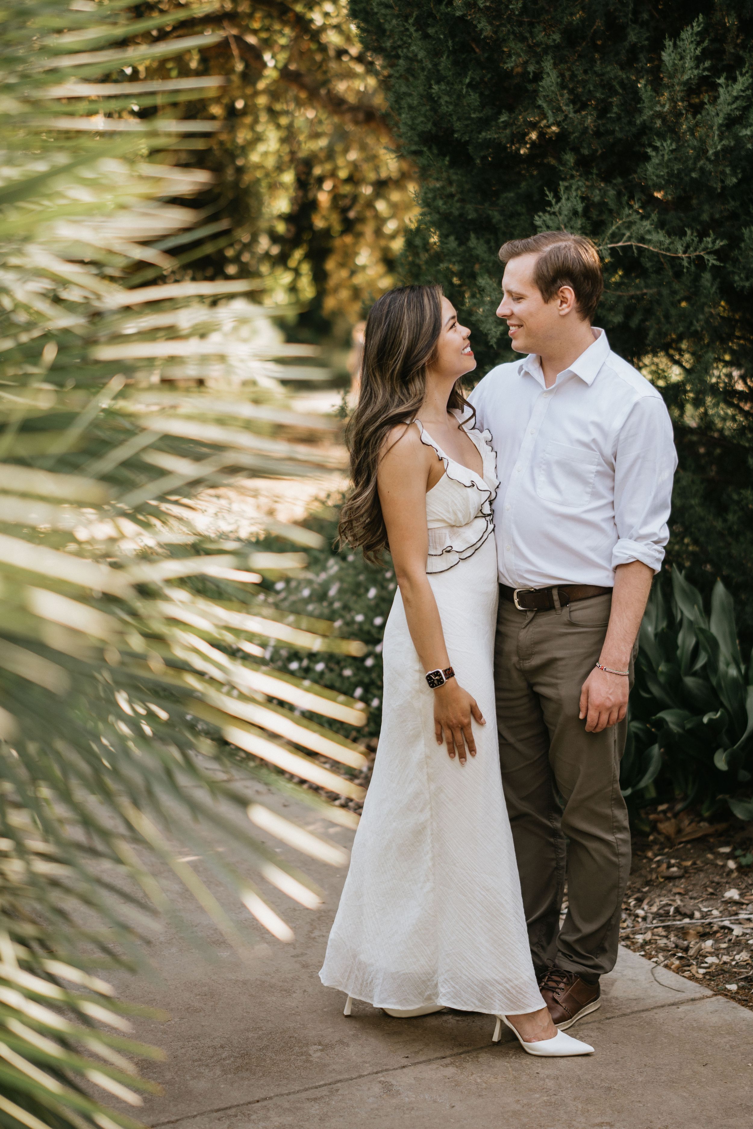 Mariel and Jeff enjoying a quiet moment along a shaded garden pathway.