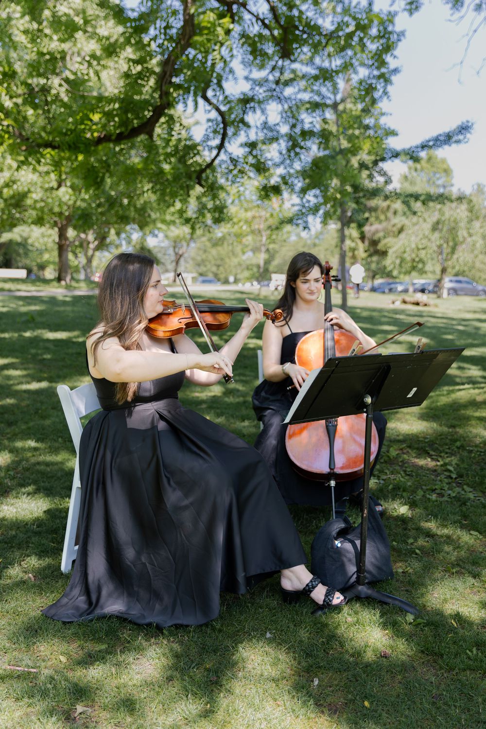 Musicians playing during a ceremony outside under the trees at the civic garden complex in london, ontario.