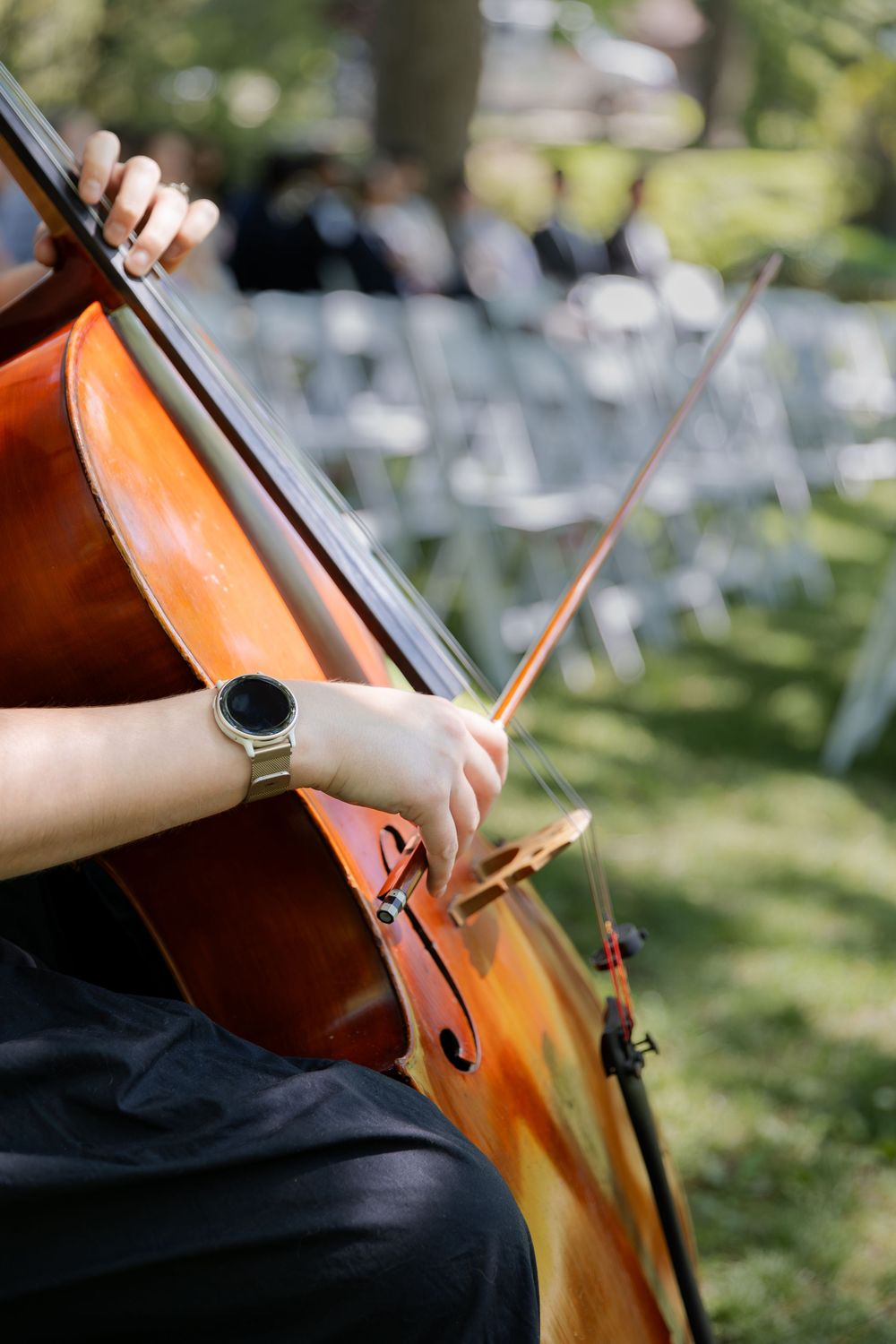 Close up of cello player playing during an outdoor ceremony at the civic garden complex in london, ontario.