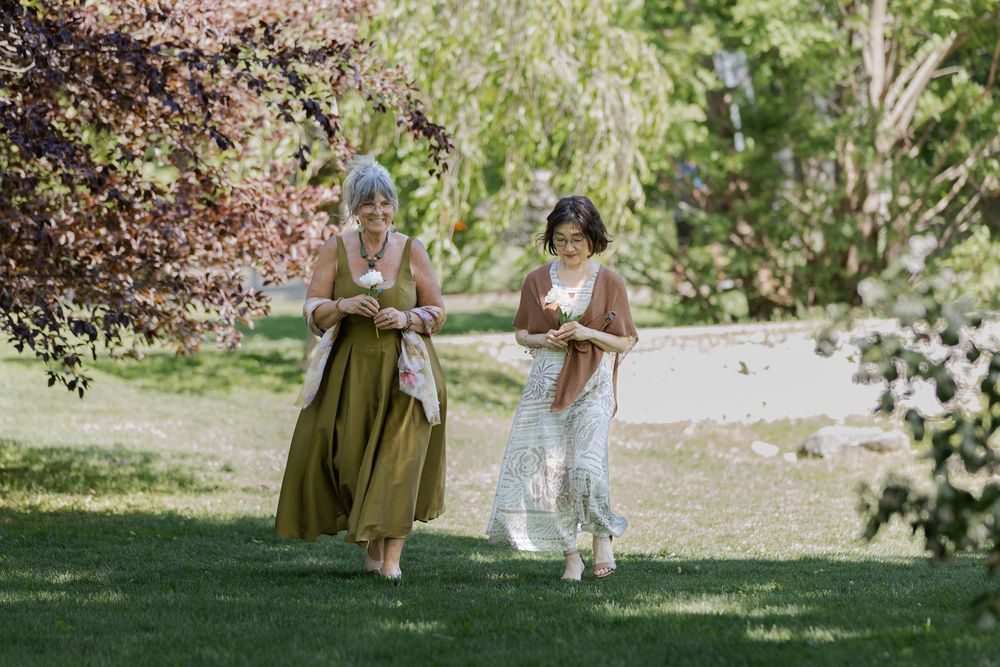 Mothers of bride and groom surrounded by greenery during an outdoor ceremony at the civic garden complex in london, ontario.