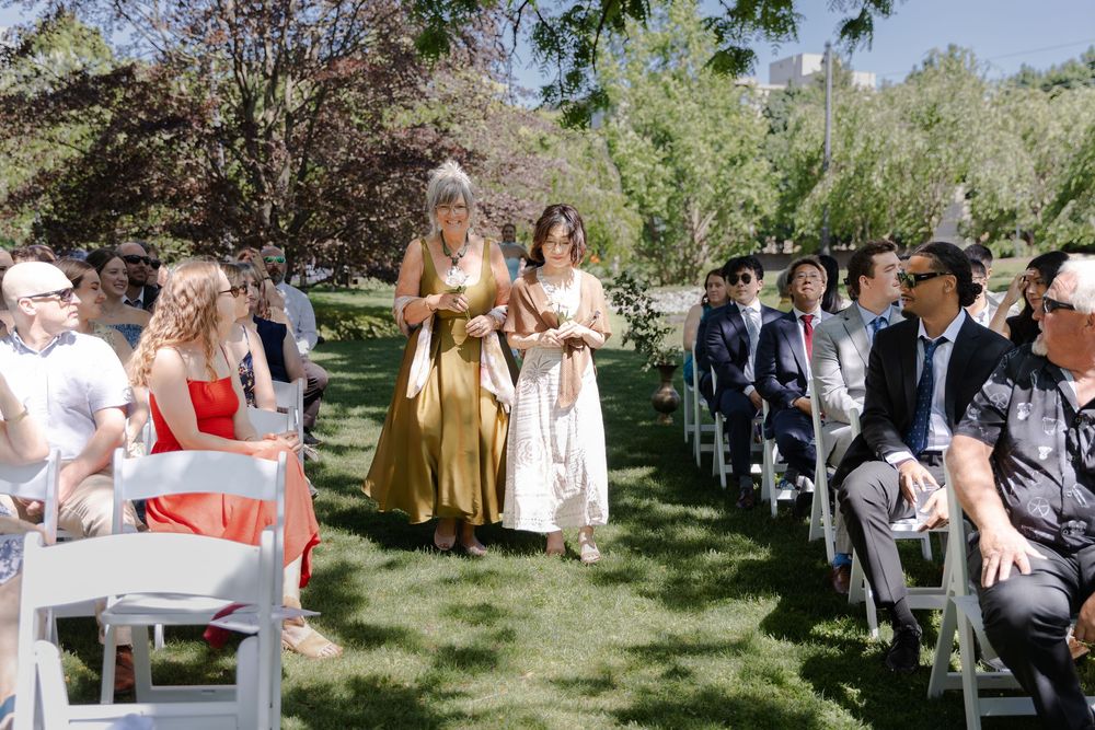 Bride & grooms mothers walking down aisle surrounded by guests at an outdoor wedding ceremony at the civic garden complex in london, ontairo