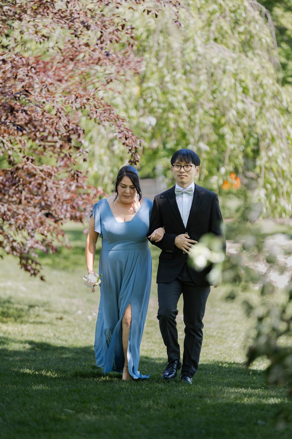 Brides maid and groomsmen walking down aisle at an outdoor ceremony at the civic garden complex in london, ontario.