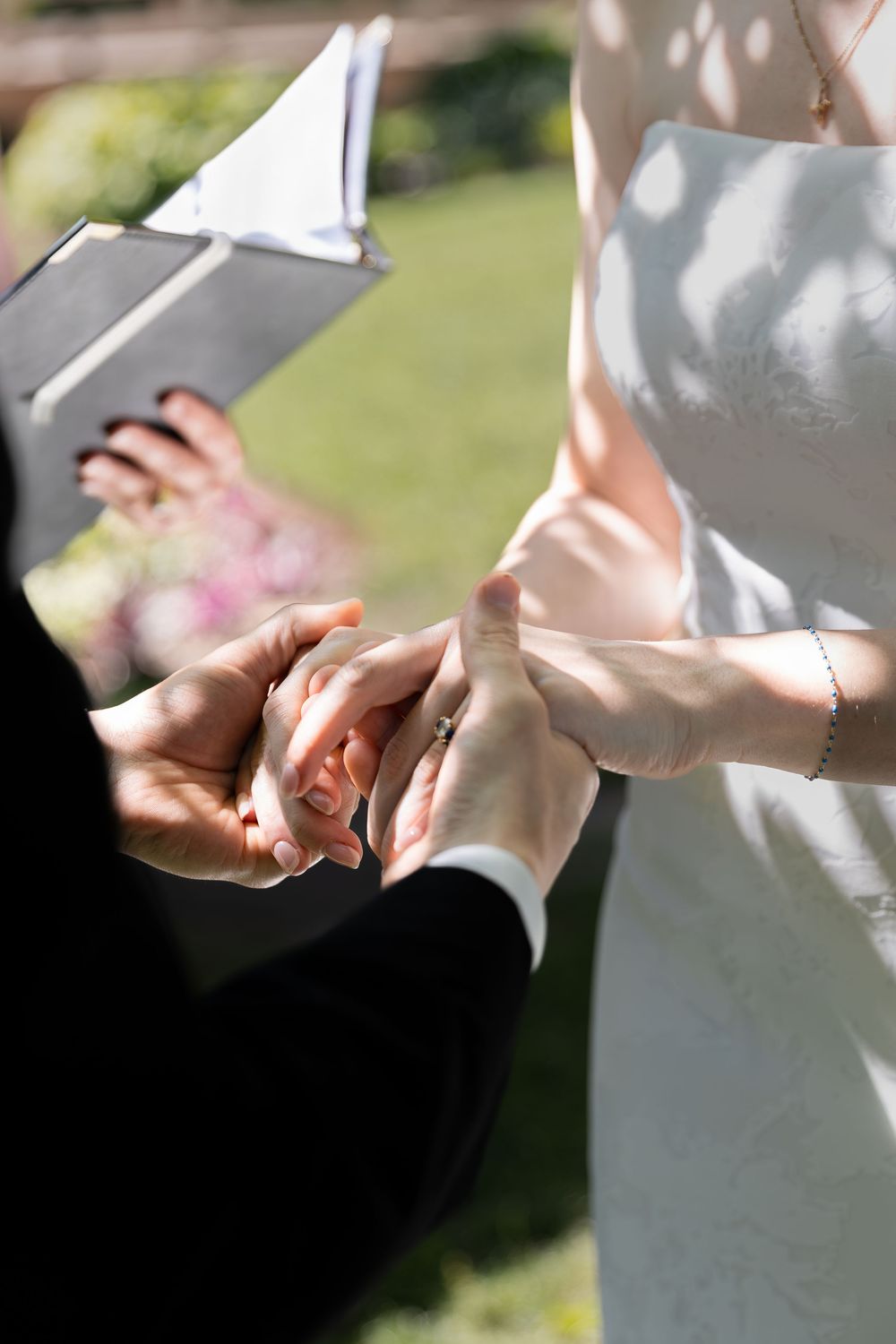 Close up photos of bride and groom holding hands during their ceremony at the civic garden complex in london, ontario.