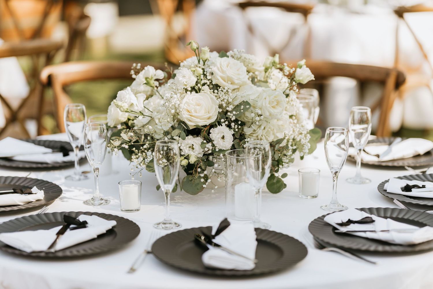 White floral centerpiece on a wedding reception table