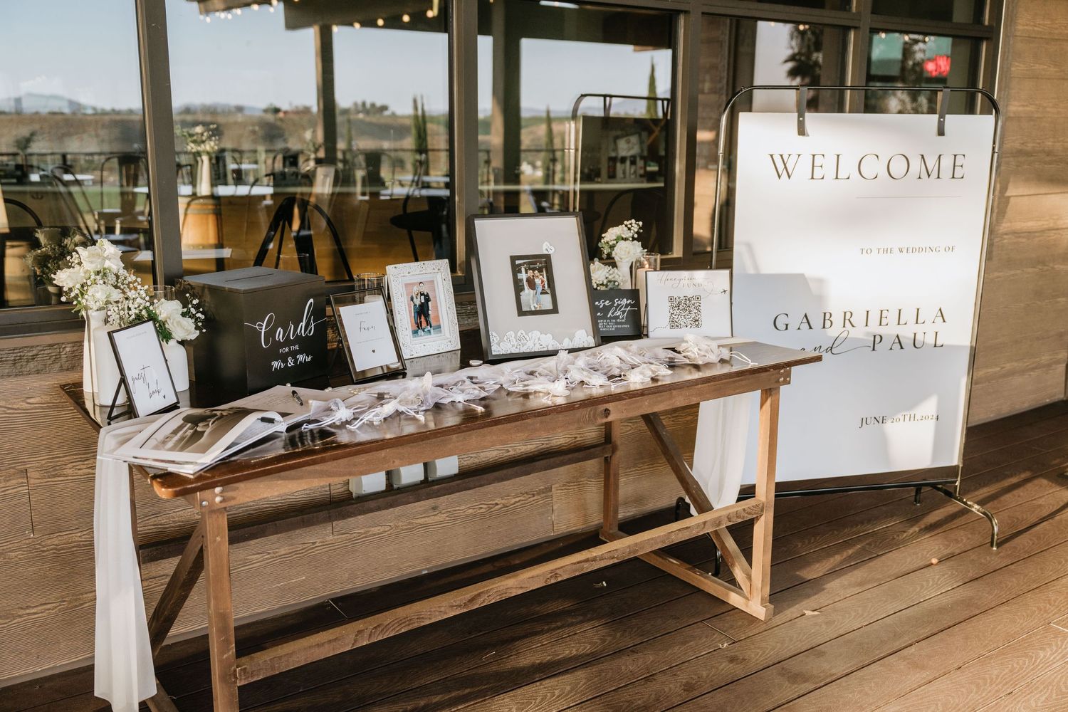 Gabriella and Paul’s wedding welcome table and framed photographs