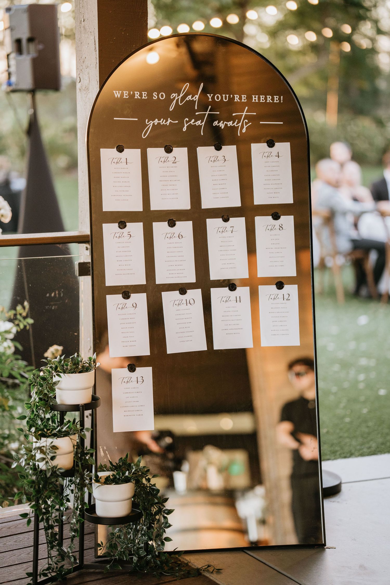 Wedding seating chart displayed at the outdoor reception