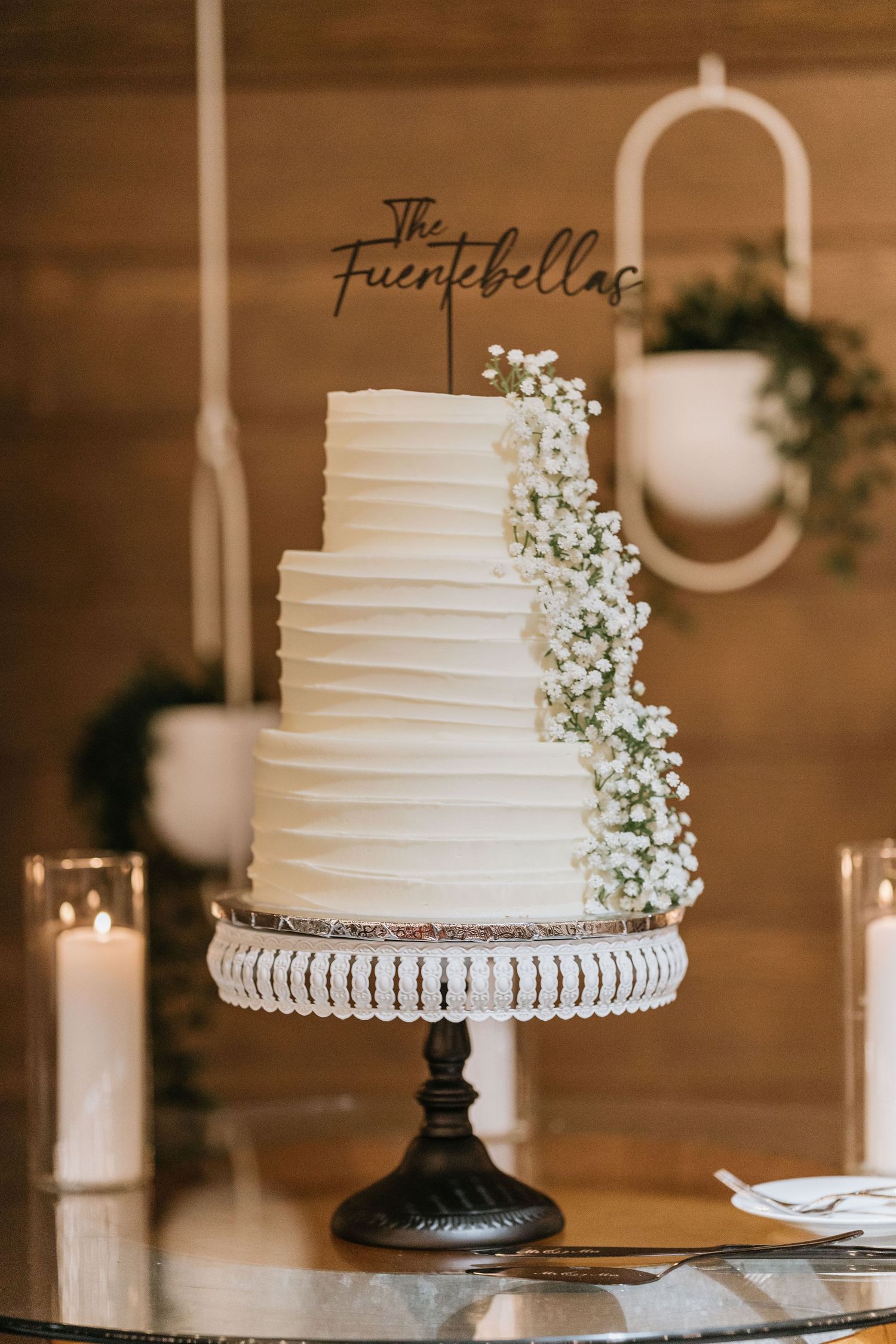 White wedding cake decorated with delicate floral details