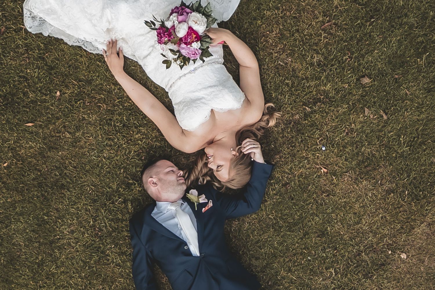 A relaxed aerial photo of couple on their wedding day