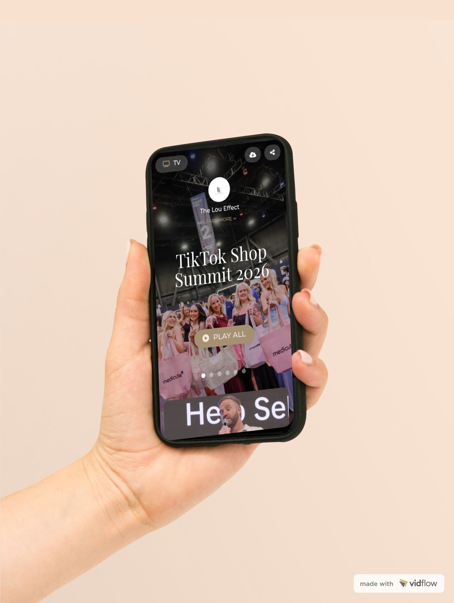 Hand holding smartphone displaying TikTok Shop Summit 2020 event promotional content on screen.