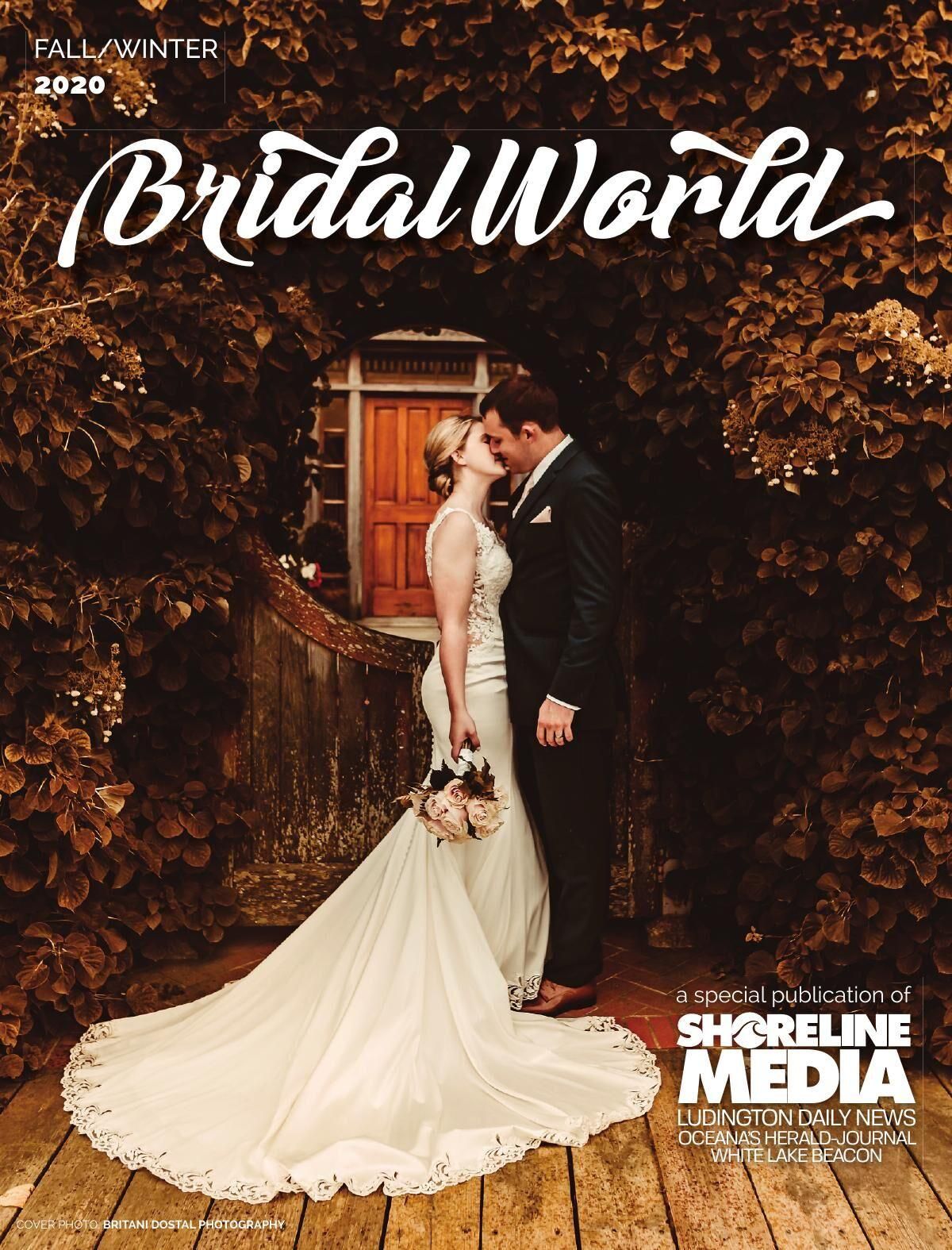 Romantic wedding magazine cover featuring a bride in a flowing lace gown posing with groom by rustic wooden door.