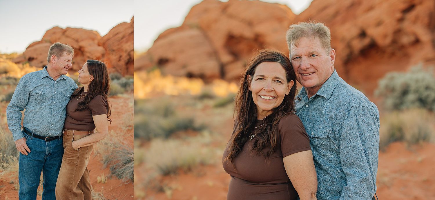 Couple poses together smiling at Red Rock Canyon desert landscape with red sandstone formations at golden hour.