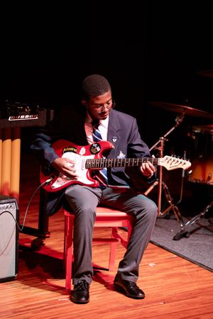 Student musician performing guitar live at the St Alban’s music recital in Pretoria.