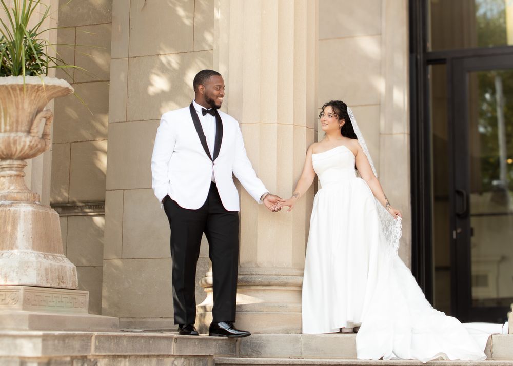 Bride and groom hold hands at the church after their wedding in Lakewood by wedding photographer, Taylor LeAnn Photography.