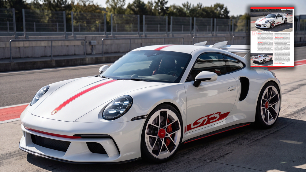 White Porsche 911 GT3 with red accents parked on a race track, showcasing its sleek sports car design.