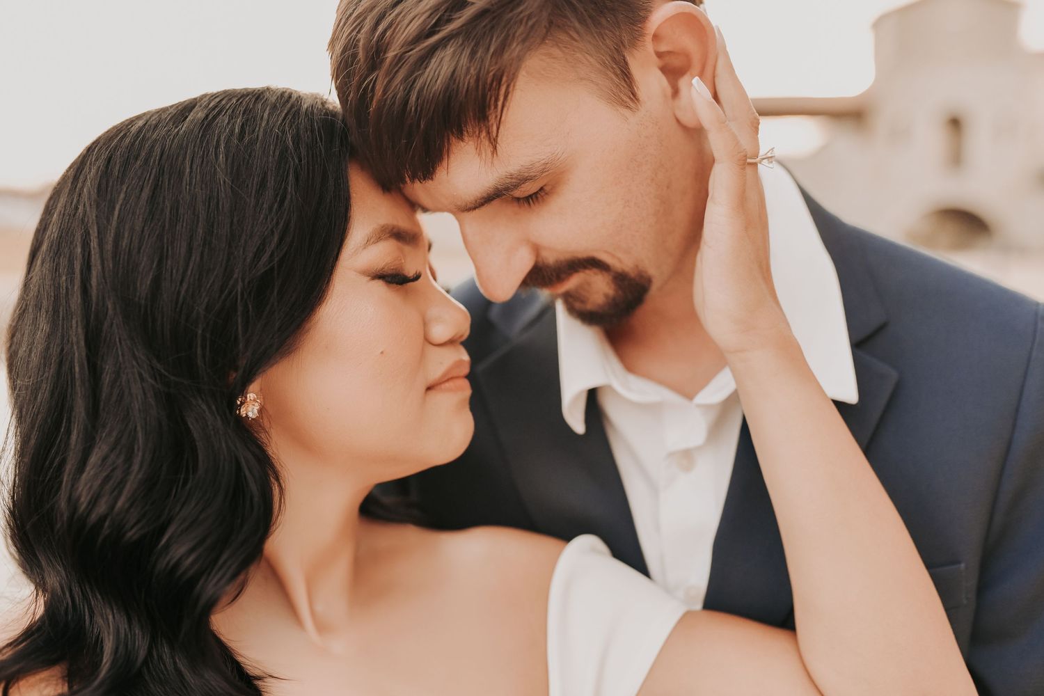 Modern editorial engagement portrait against the European-inspired stone architecture at Chapel at Palacios
