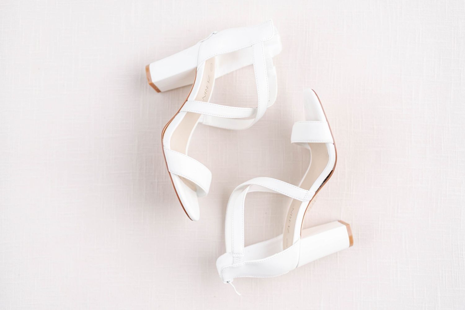 White block heel sandals with ankle straps displayed on a white background, perfect for bridal or formal occasions.