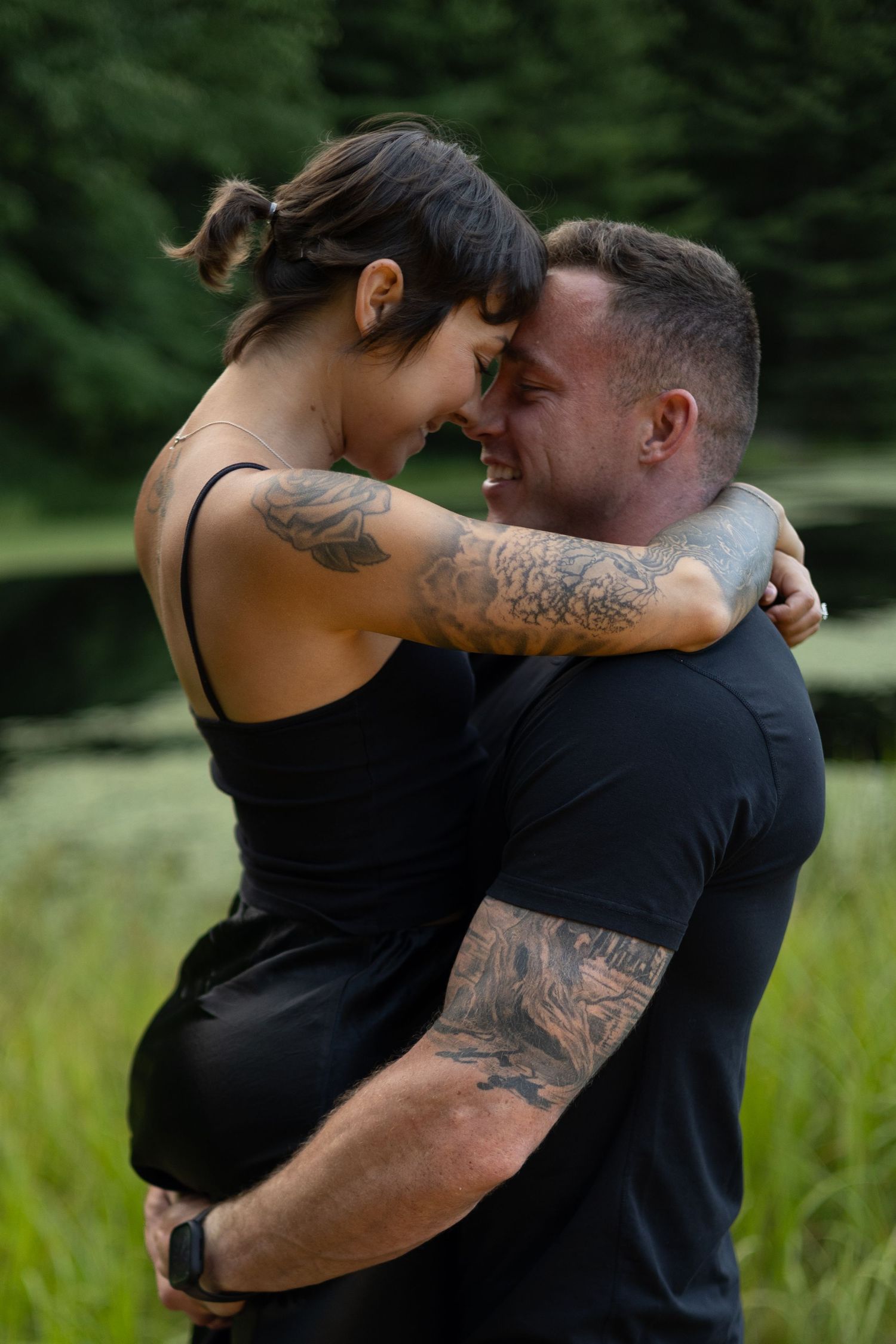 An engaged couple embracing during a golden hour outdoor photo session