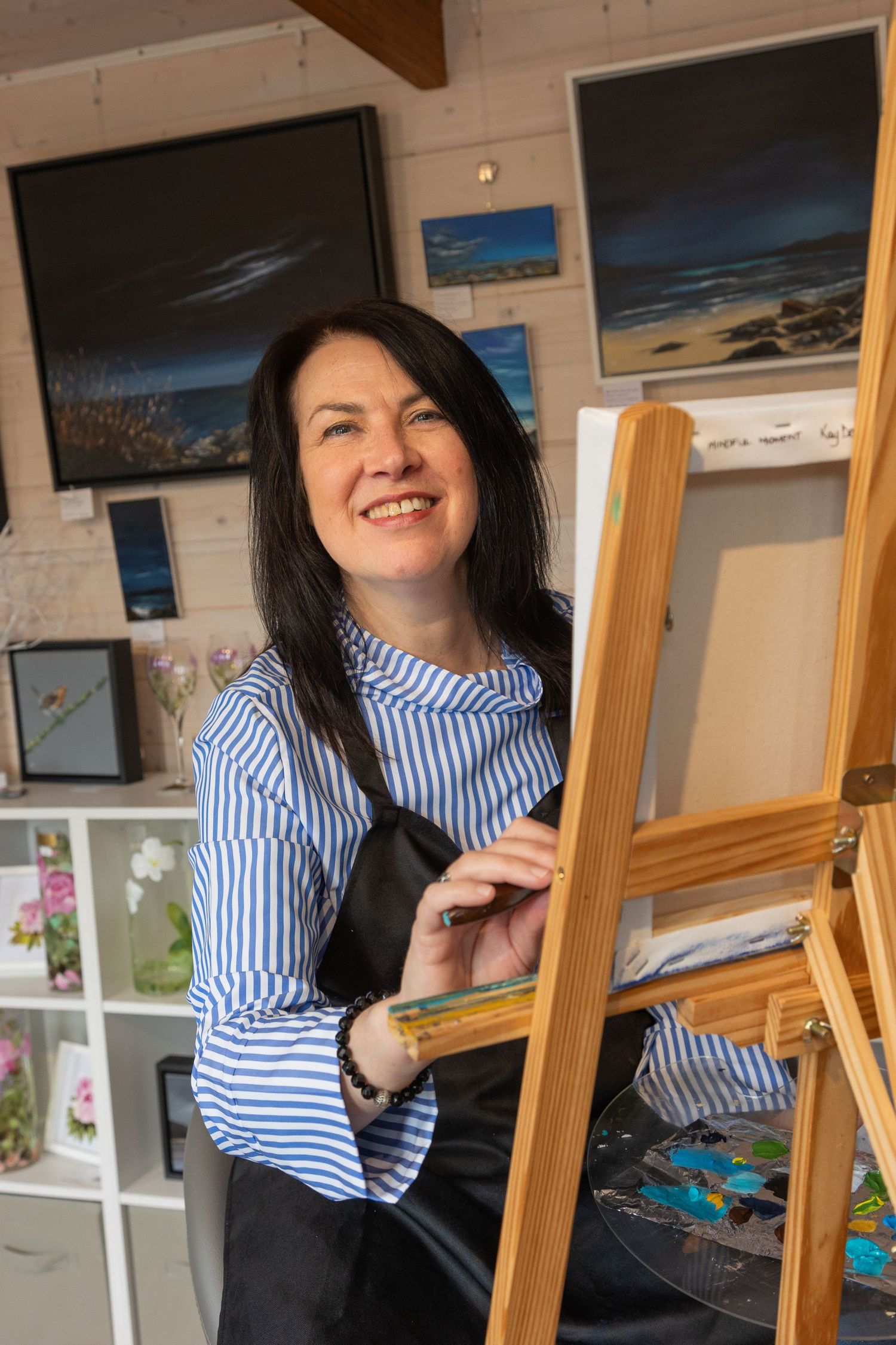 Female artist painting at her easel