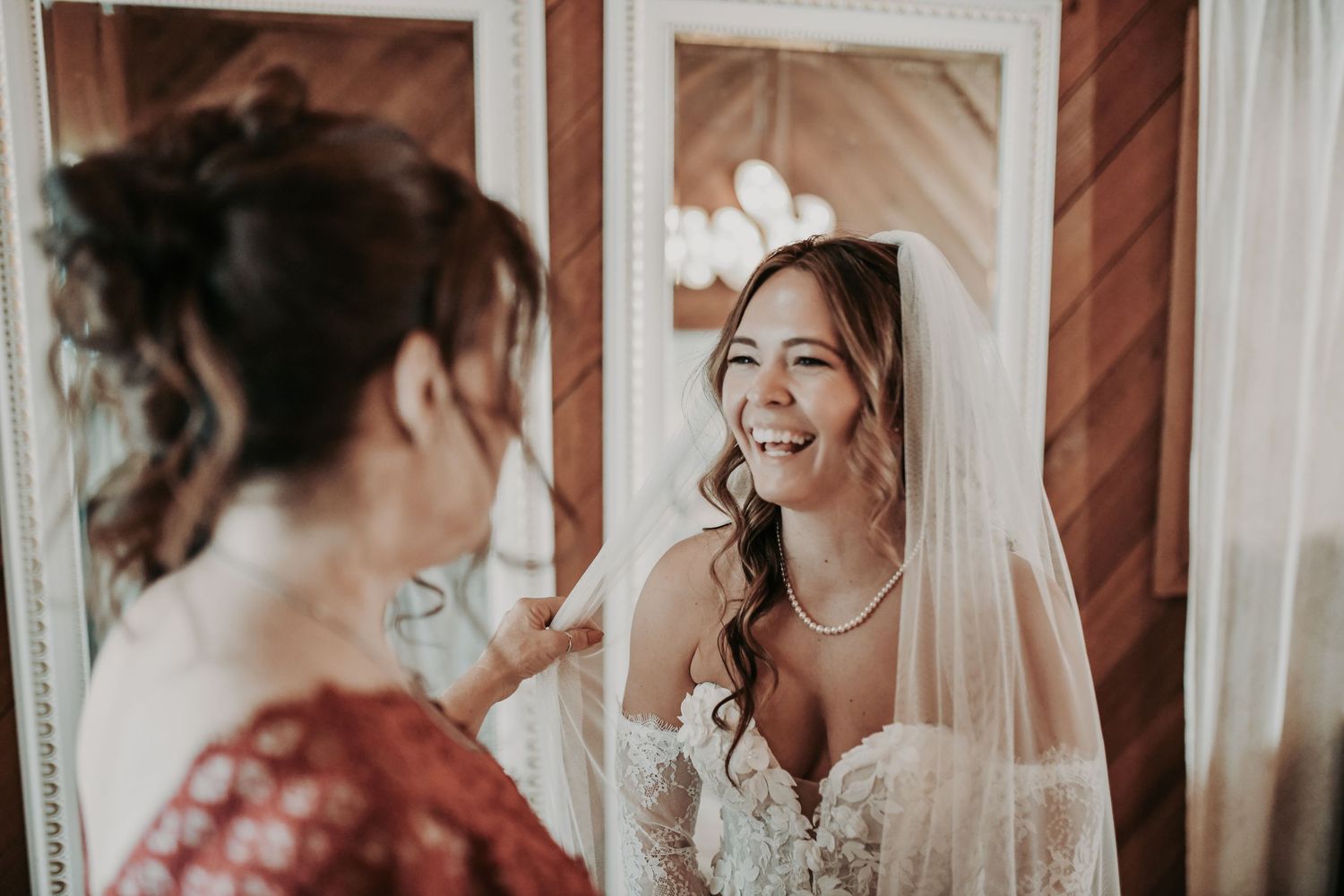 Mother helping the bride put on her wedding veil at Lucky Spur Ranch