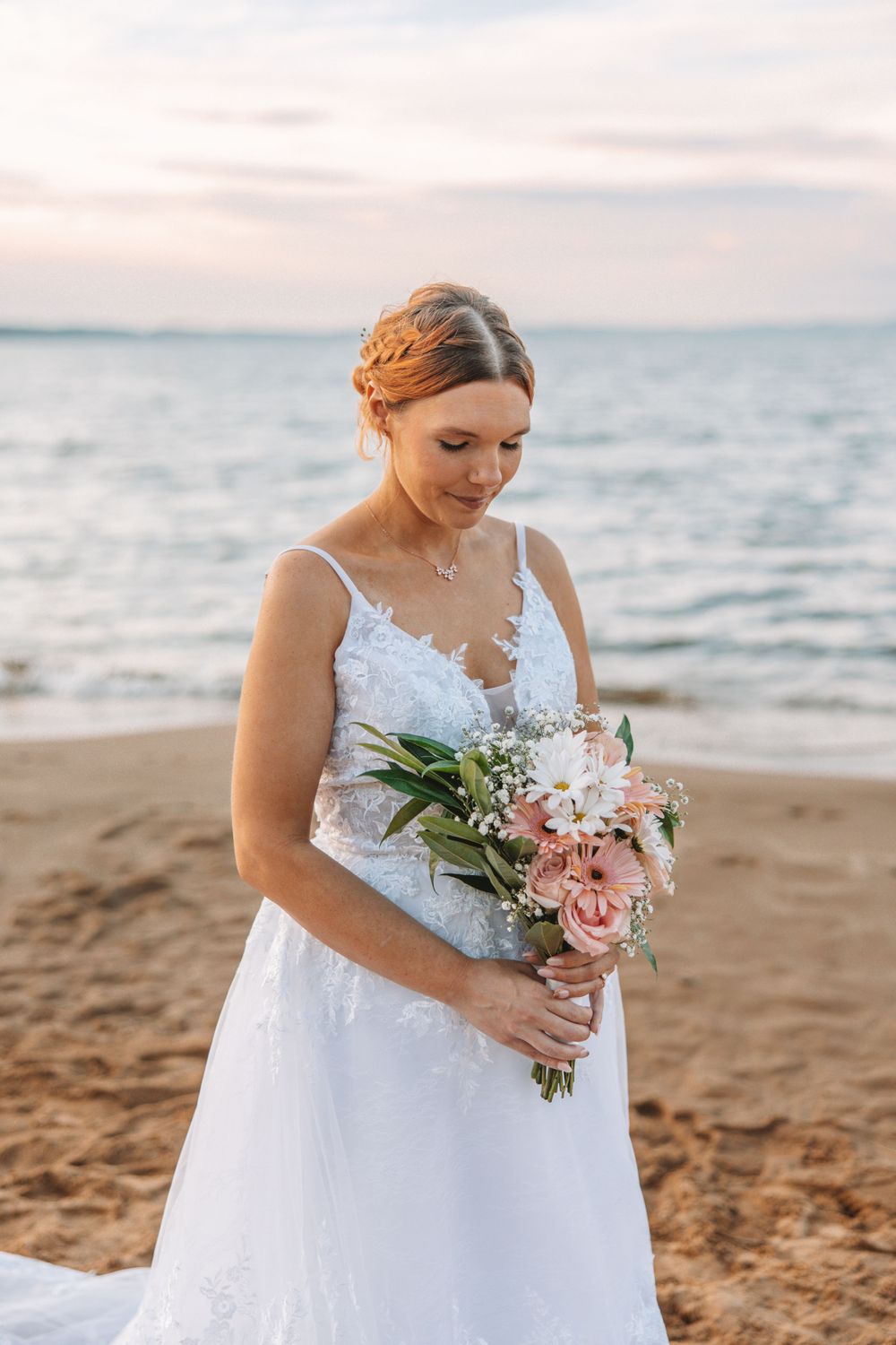 bride posing by the water in Traverse City