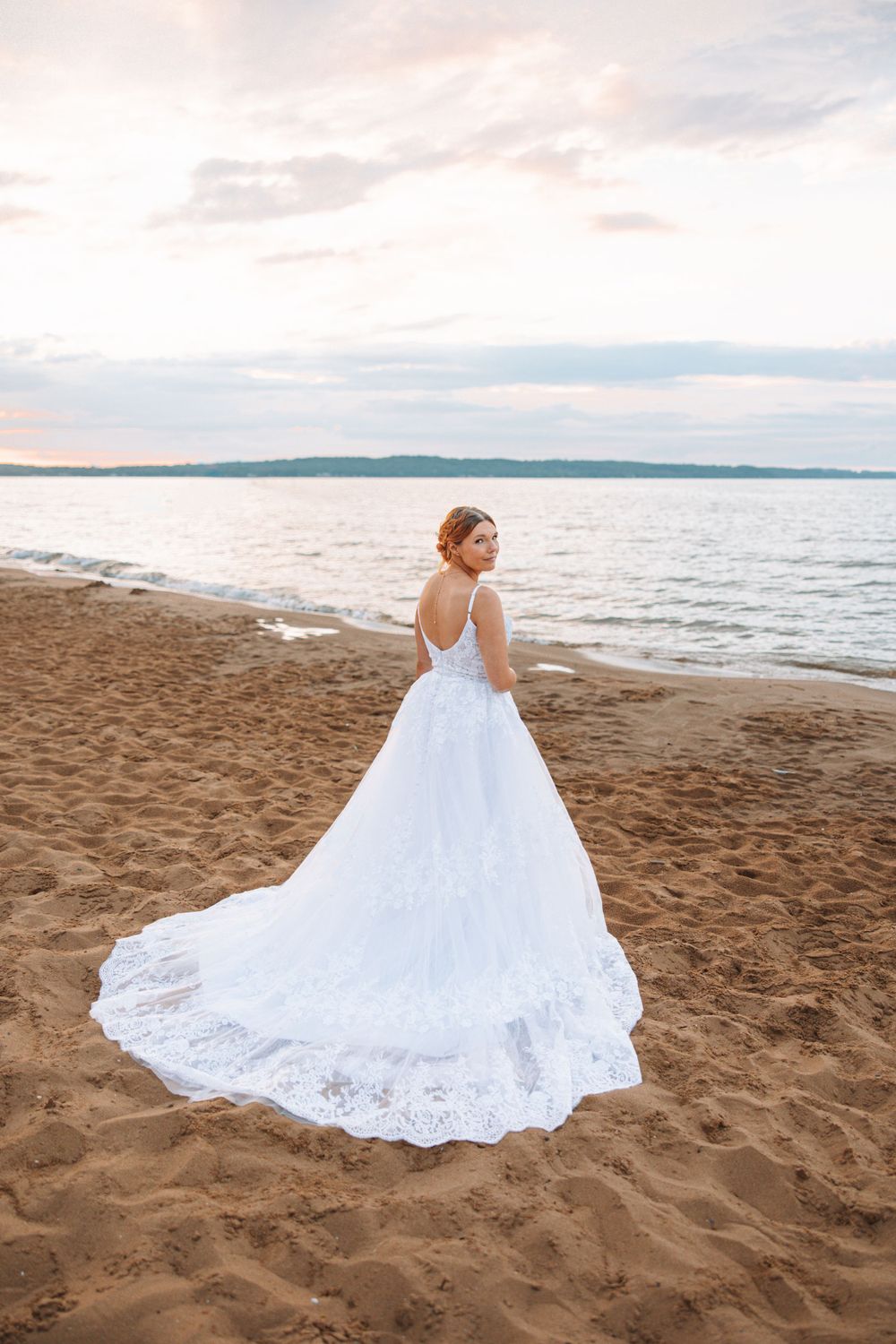 bride posing by the water in Traverse City