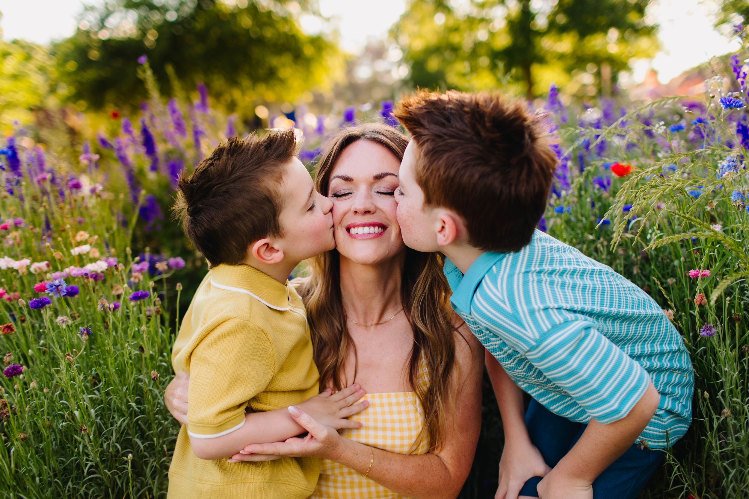 Giving mom a smooch during a family session in the wildflowers.
