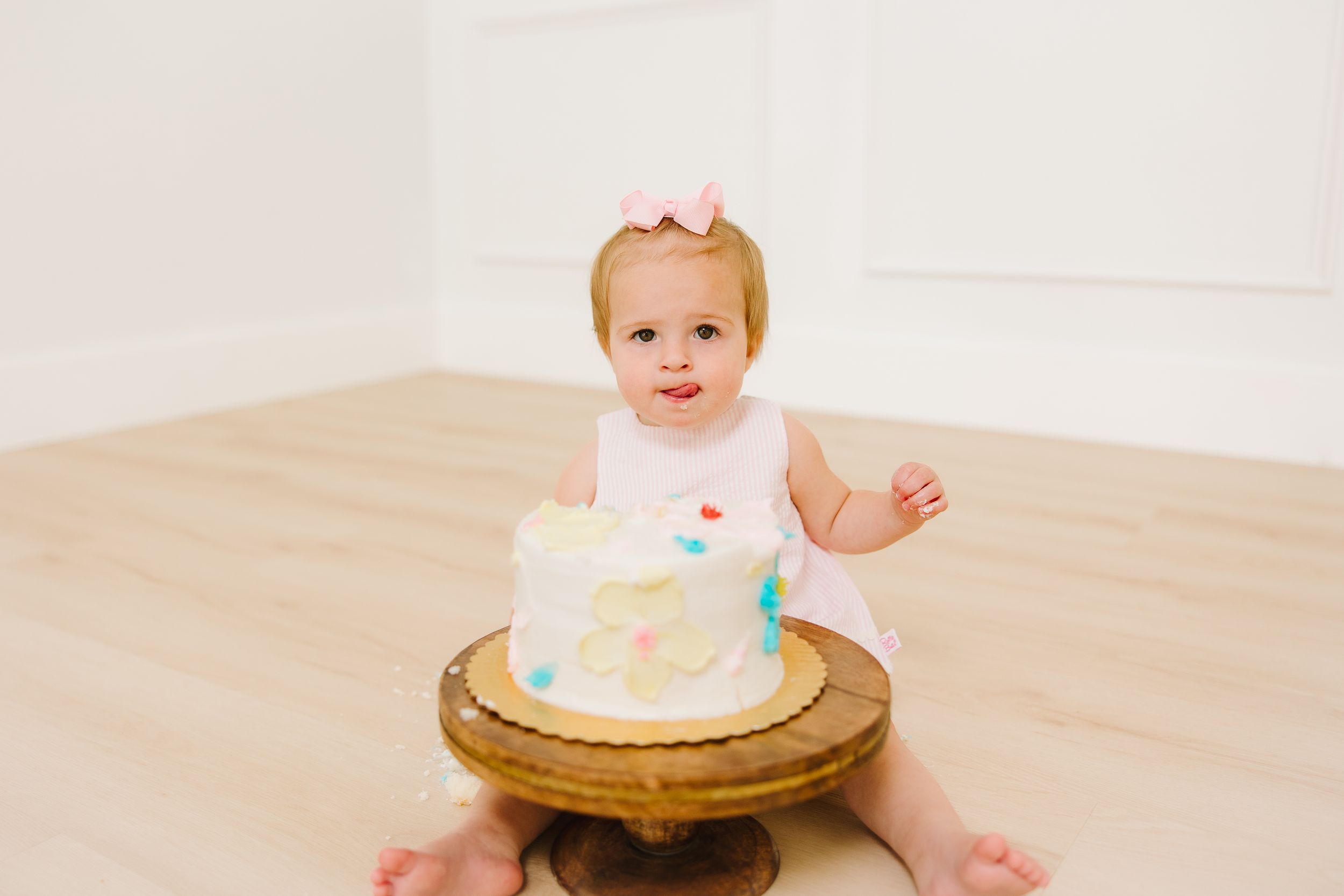 Diving into her cake during her one year photo session.