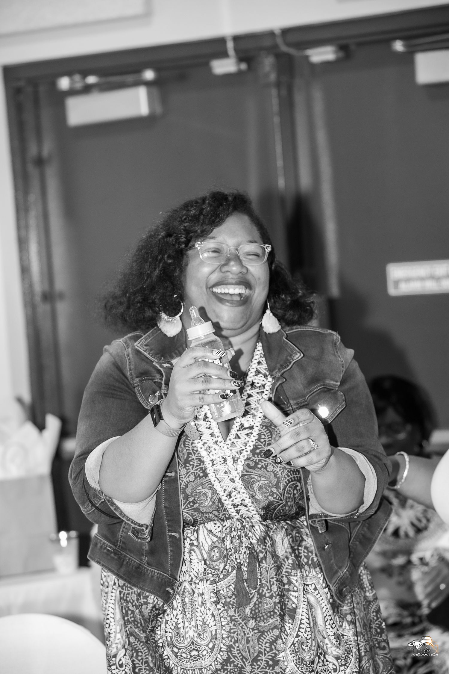 A joyful moment captured in black and white at an indoor celebration.