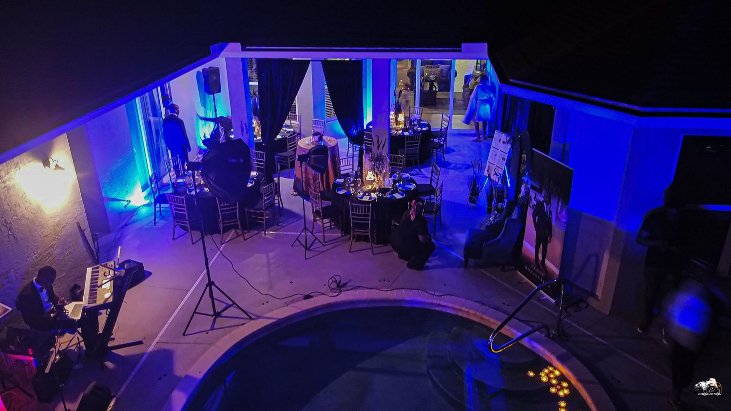 A performance stage setup with blue lighting and musical equipment.