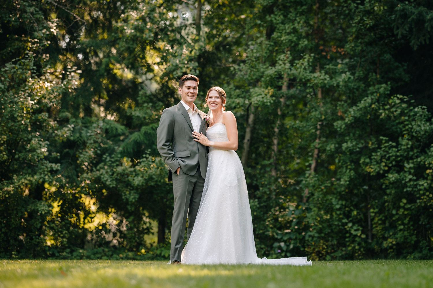 A romantic wedding portrait of couple standing together in a lush garden setting during golden hour in Hood River at Mount Hood Organic Farm
