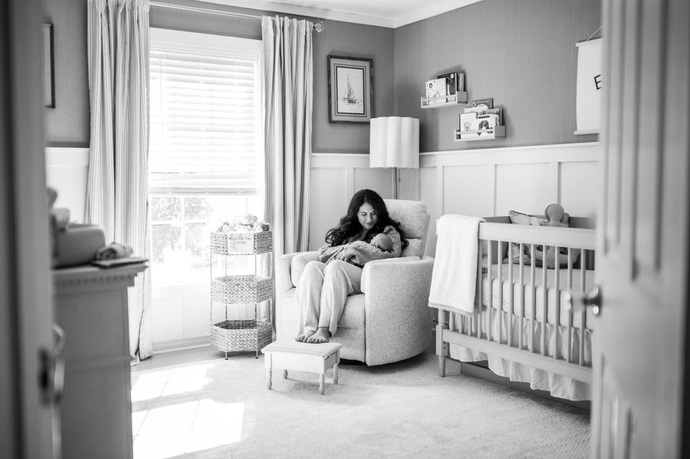 Black and white image of a quiet moment in a modern gray and white nursery.