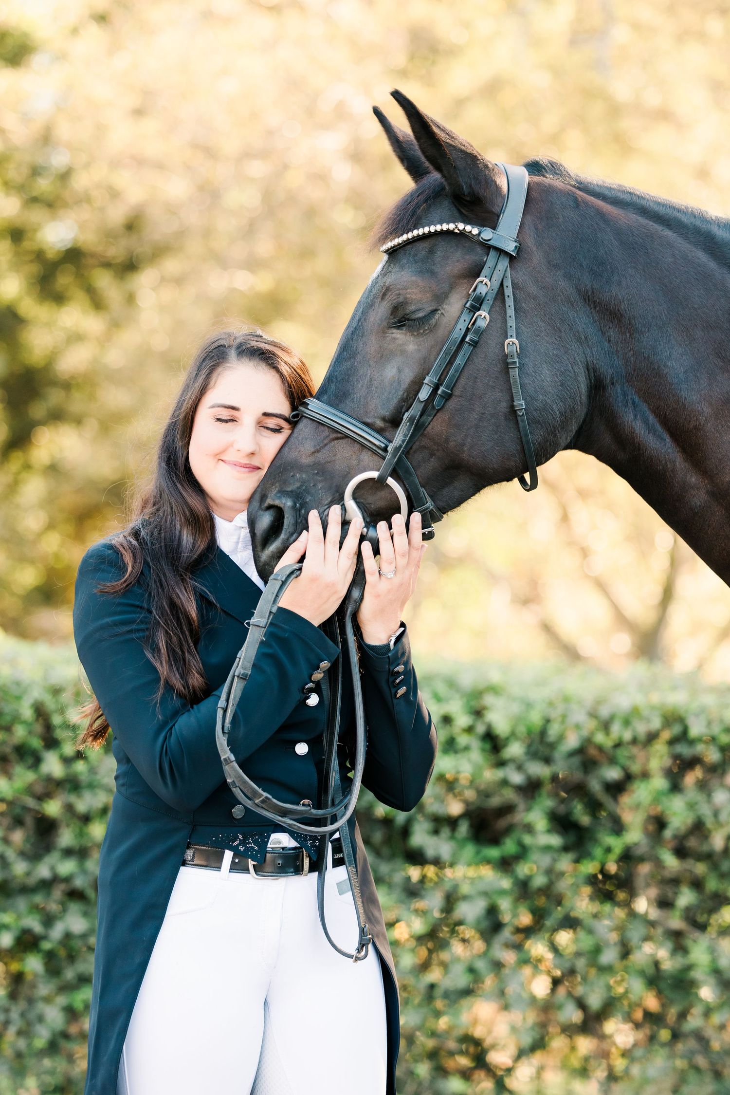 Black horse and rider sharing a tender moment during an equestrian portrait session.