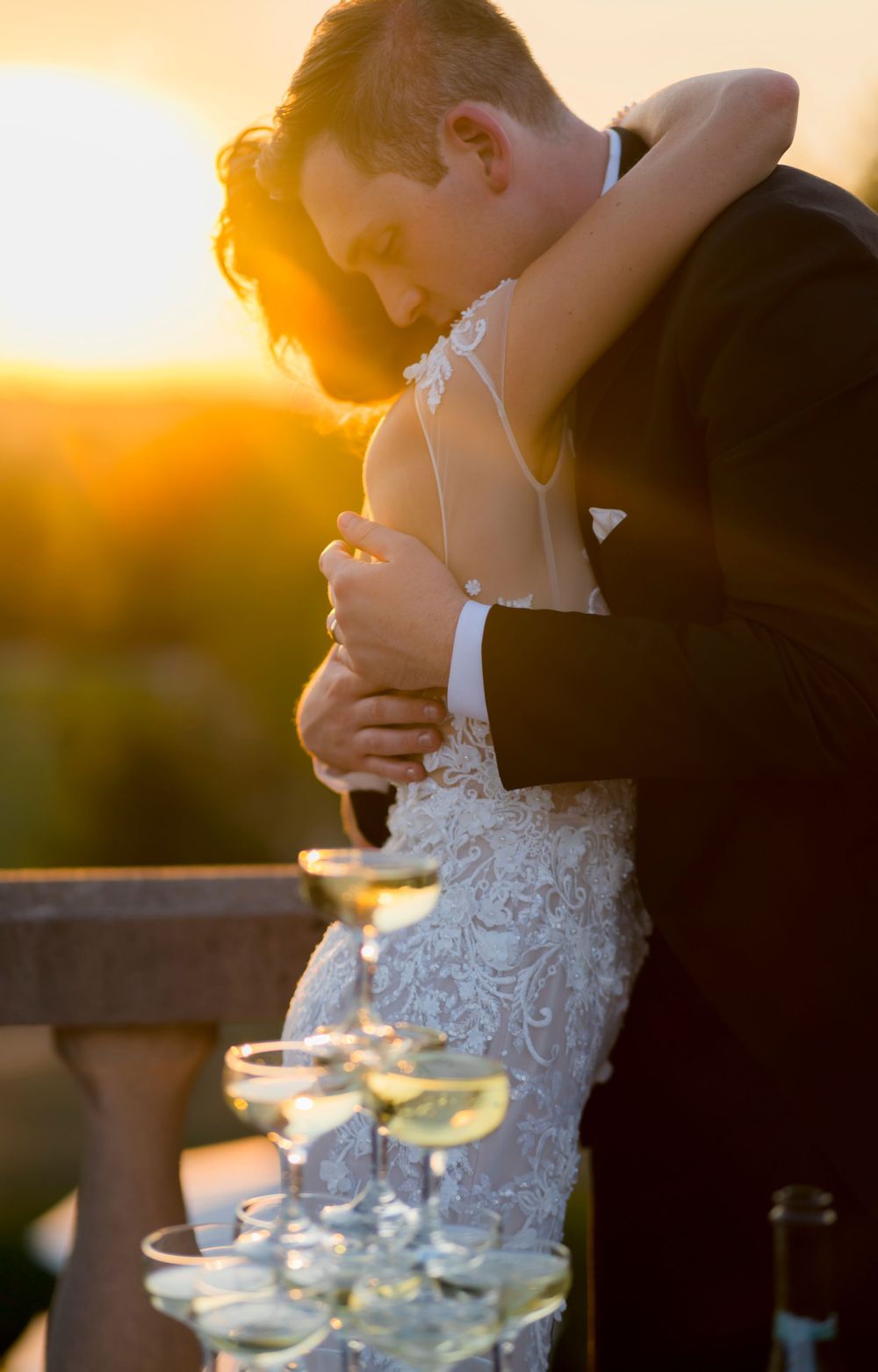 Romantic sunset moment with champagne glasses on an outdoor terrace.