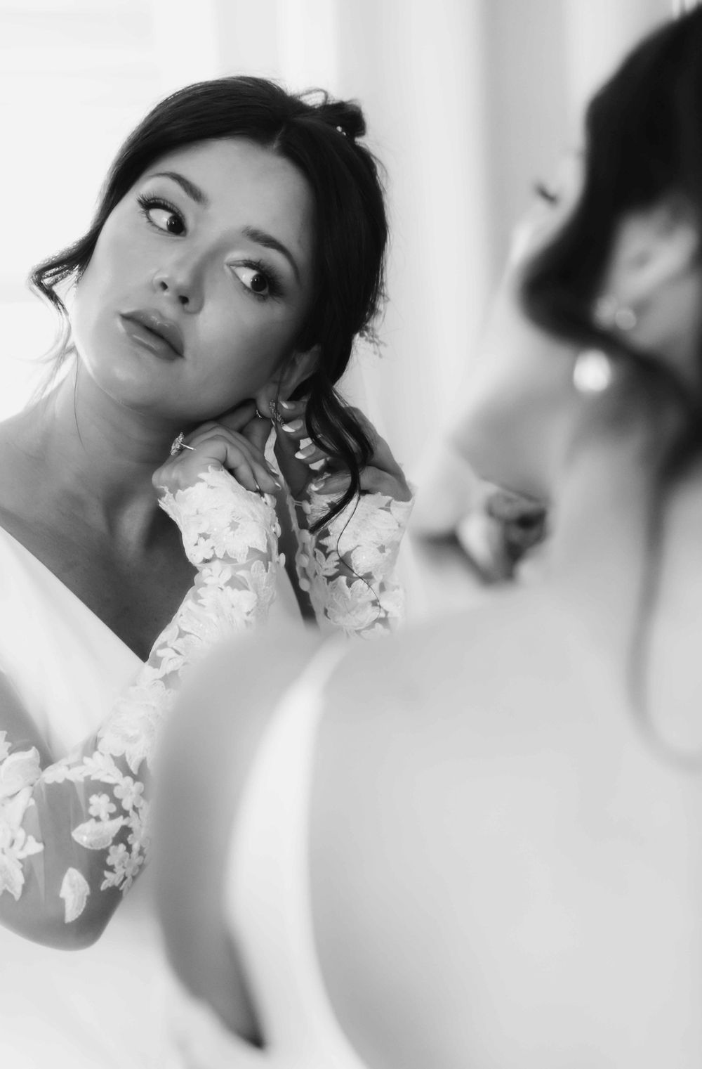 Artistic black and white bridal portrait reflecting in mirror.