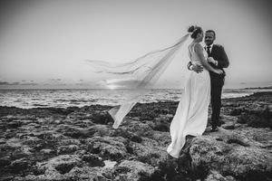 Bruidspaar aan zee in Puglia bij zonsondergang, vastgelegd door Bart Boodts, huwelijksfotograaf gespecialiseerd in destination weddings