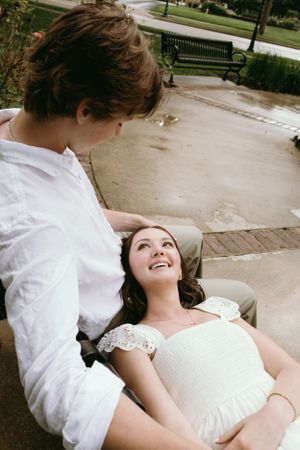 Couple shares an intimate moment on concrete steps.
