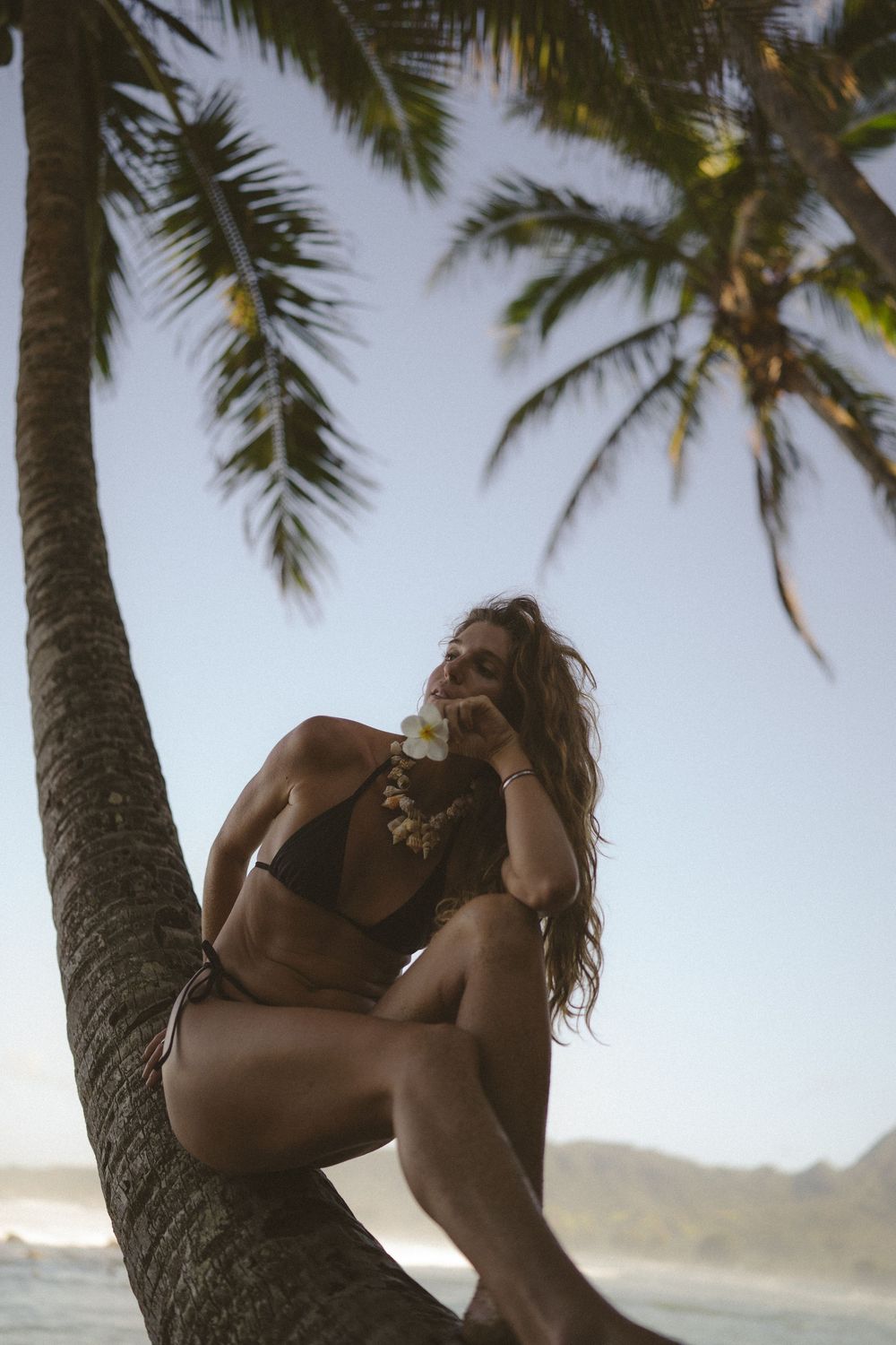 Model posing with palm trees on Kauai