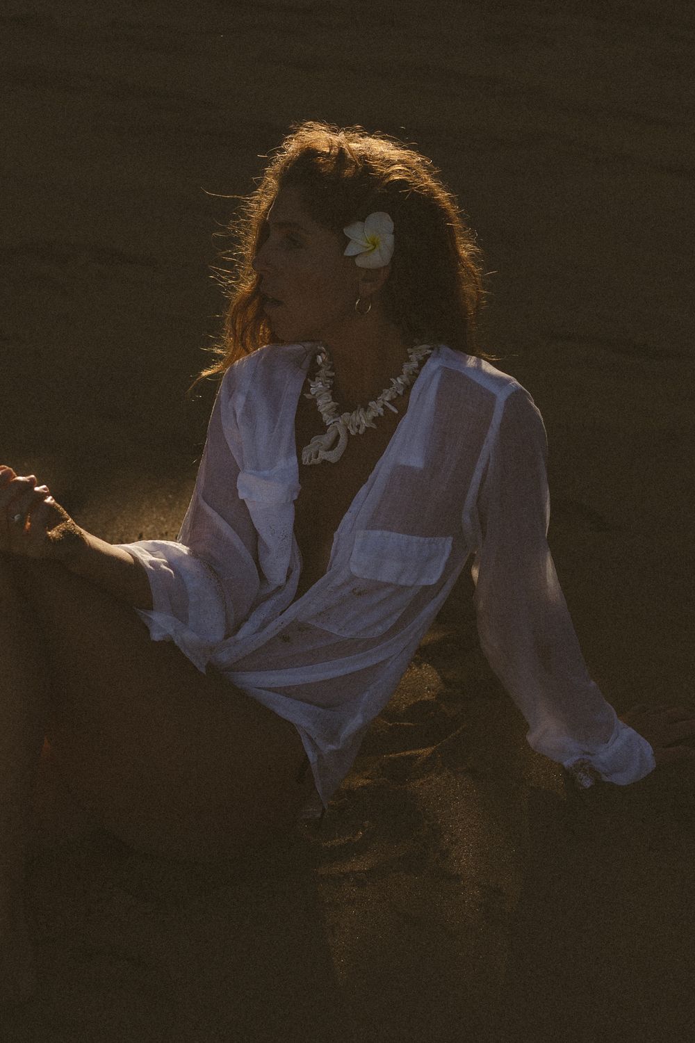 Model posing with shell belt on Kauai