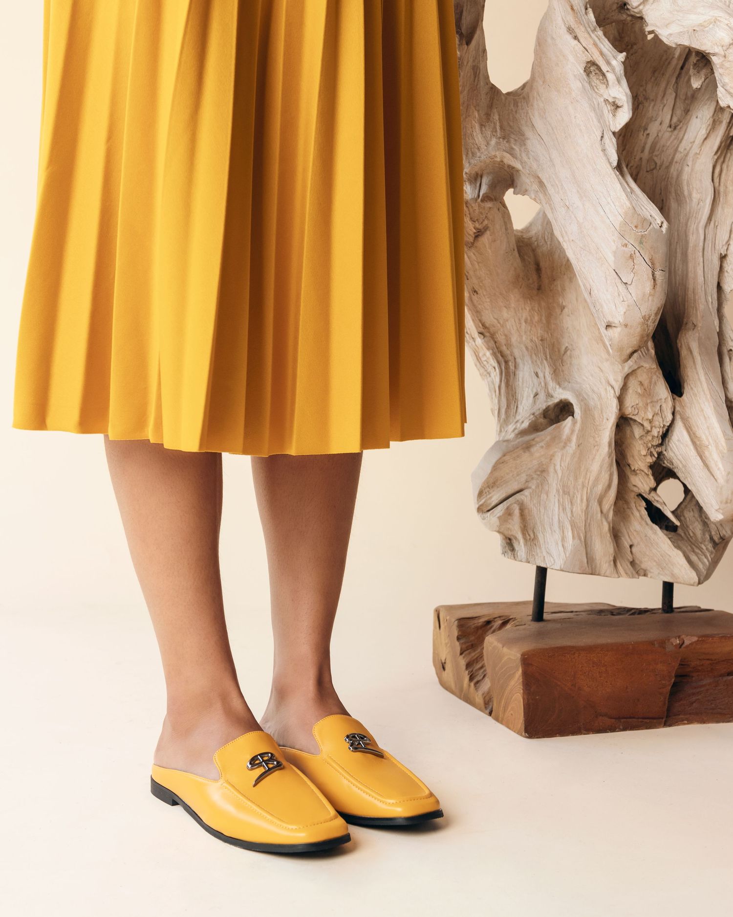 Yellow leather ballet flats with pointed toes and ankle straps shown from multiple angles against a white background.