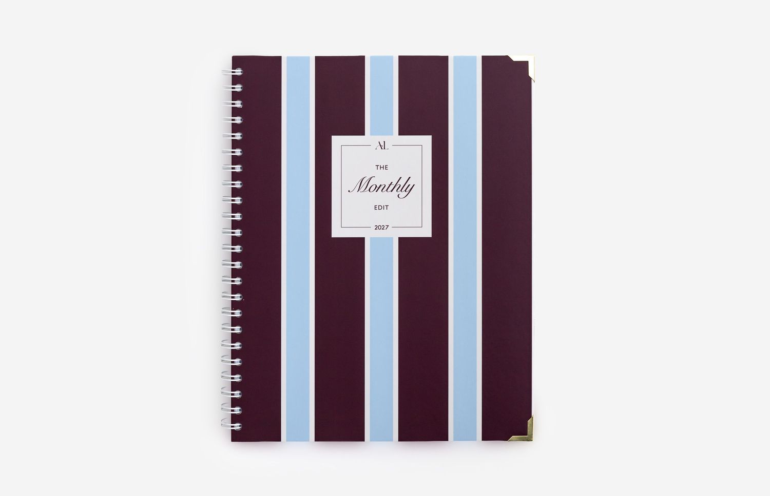 Spiral-bound monthly planner with burgundy and light blue vertical stripes on the cover.