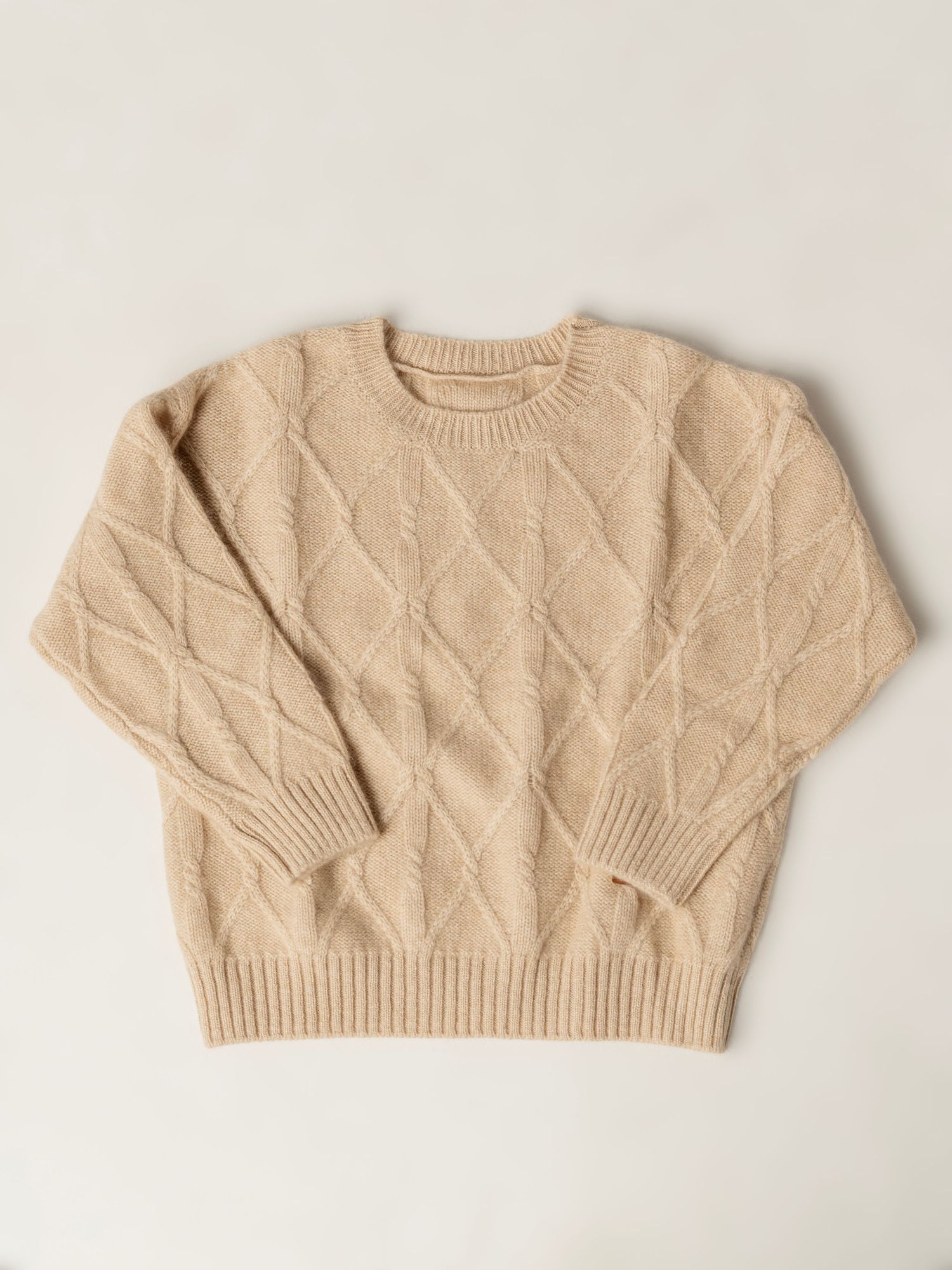 Beige cropped cable knit sweater with ribbed edges and short sleeves shown from different angles on plain background.