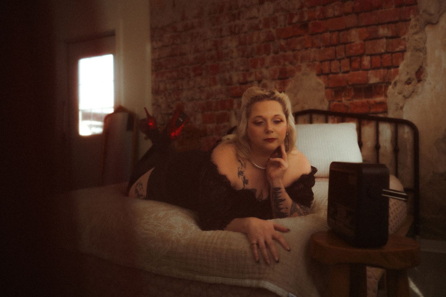 A candid photo showing someone posing against a brick wall background at a studio in Lexington, South Carolina