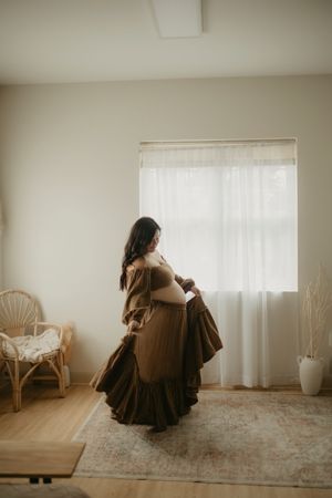 A series of moody indoor portraits showing a figure in a brown dress against white walls and curtains.