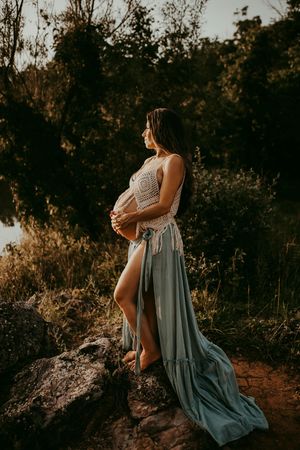 Artistic outdoor portrait session at sunset featuring flowing blue dress.