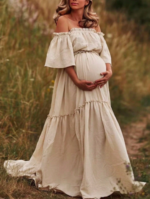 Maternity fashion photos featuring flowy white dresses in an outdoor natural setting.