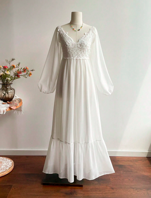 White cotton dresses displayed on mannequins against a clean white studio background.