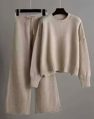 Cozy beige knit sweater and wide-leg pants set featuring a cropped pullover and drawstring waist bottoms.